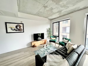 A sophisticated setting featuring a sleek entertainment area, contemporary art, and a cozy atmosphere.