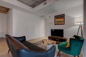 A different angle showcasing the refined design, plush seating, and minimalist entertainment setup.