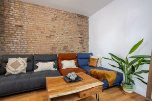 Living Room: Spacious and eclectic with plush seating and leafy accents—perfect for winding down