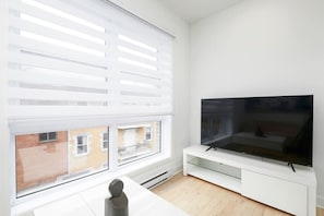 Stream your favorites on the Smart HD TV while natural light pours in from the large corner window—comfort meets brightness