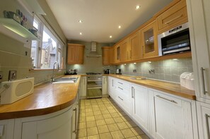 Kitchen includes a fridge/ freezer, dishwasher, Smeg oven, gas stove, and a Nespresso coffee machine