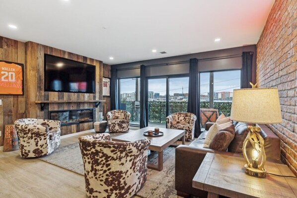 Living room with pull out sofa, fireplace, Smart TV, patio access and more