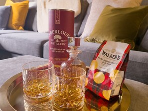Enjoying a local whisky at Fraser Cottage