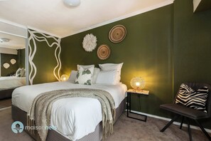 Large separate bedroom with plush king size bed