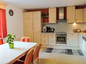 Furniture, Kitchen, Interior Design, Flooring, Countertop, Wood, Cabinetry, Kitchen Appliance, Floor, Major Appliance