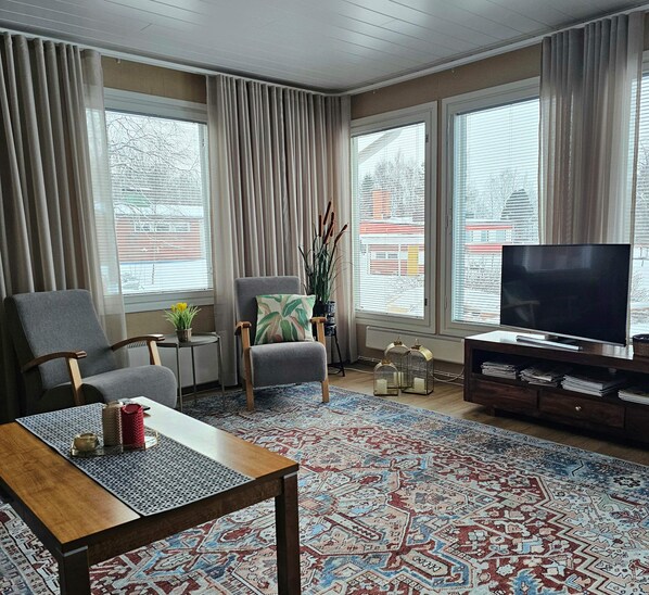 Living room is spacious and with many windows it is also very bright.