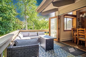The dining room seamlessly opens to an inviting outdoor living space, ideal for open-air meals and relaxation.