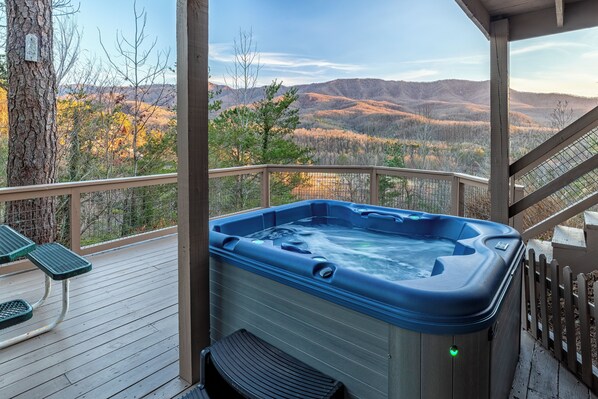 Relax in the hot tub on the lower deck, surrounded by stunning mountain views.