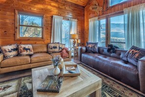 Enjoy the warmth of a wood-burning fireplace, a 65” TV, and rustic charm. 