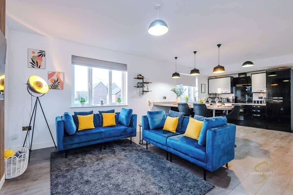 Bright & Stylish Living Space – This elegantly designed living area features a cosy sofa, warm lighting, and contemporary décor, creating the perfect spot to relax.