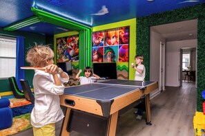 Fun-filled Mario-themed game room with ping pong, gaming chairs & vibrant decor!