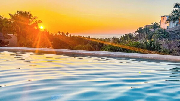 The pool area, bathed in the warm glow of the setting sun. 