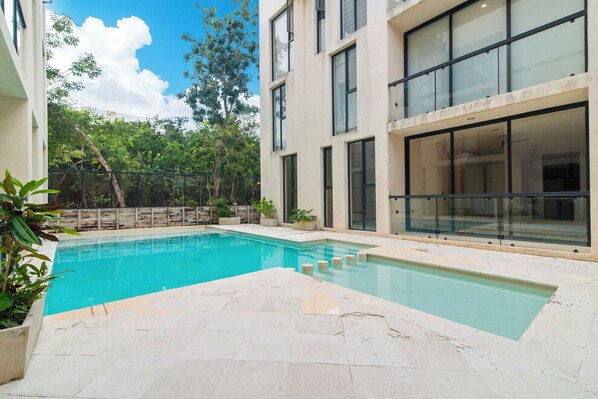 Enjoy a peaceful afternoon lounging by the serene poolside area