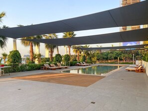 Poolside Retreat: Unwind under shaded cabanas with stunning palm views and a refreshing dip!