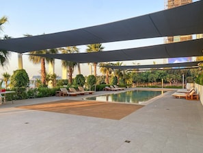 Poolside Retreat: Unwind under shaded cabanas with stunning palm views and a refreshing dip!