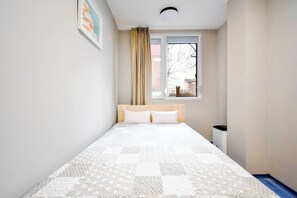 Wake up to natural light in this inviting bedroom, designed for a restful night’s sleep.