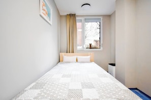 Wake up to natural light in this inviting bedroom, designed for a restful night’s sleep.