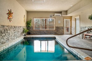 Indulge in the warmth of the private pool in this cabin, where the soothing hot water offers a peaceful retreat amid stunning surroundings.