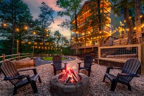 Experience the magic of the mountains at night—luxury cabins illuminated under the stars with a cozy fire pit to gather around.