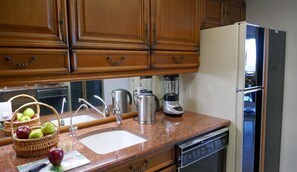 The cozy kitchen with custom granite countertops, Kohler sink and much more.