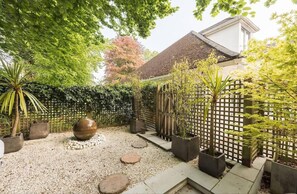 Lush oasis garden with running water feature.