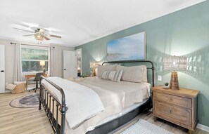 Primary bedroom has a comfy king bed with beautiful views of water