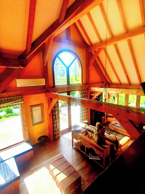 The family room with its cathedral ceiling, exposed beams and limeplaster walls