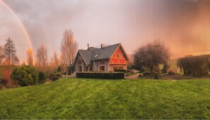 An incredible photo of this magnificent home glowing under light of a rainbow
