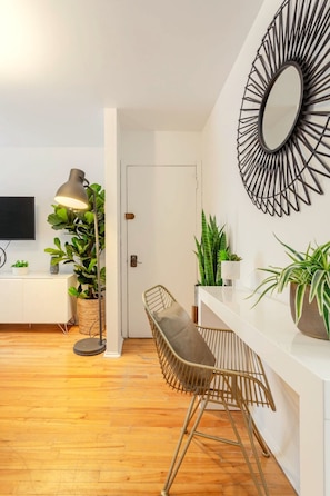 Living Room: Clean lines and vibrant greenery meet easygoing boho charm
