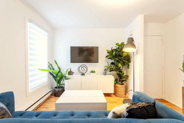 Living Room: Bright and airy with a sleek setup perfect for unwinding or streaming your favorites