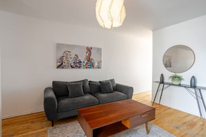 Modern lounge with sofa, coffee table, and wall art