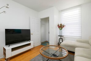 Living Room: Neutral hues and curated decor blend for a stylish space to unwind or stream