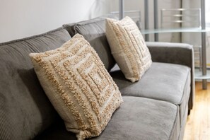 Sink into comfort with plush pillows and a modern sofa setup.