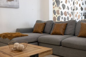 Modern sectional with soft textures and a natural-toned centerpiece