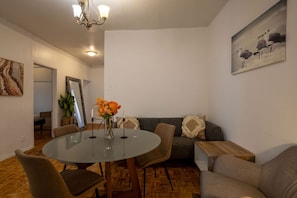 Open-plan dining and lounge with elegant round table and modern seating