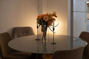 Chic glass-top table with fresh floral centerpiece.