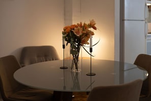 Chic glass-top table with fresh floral centerpiece.