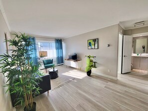 An airy and bright living room with elegant décor, offering the perfect space to relax or entertain guests.