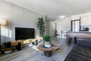 A modern and inviting living space with sleek decor, warm natural light