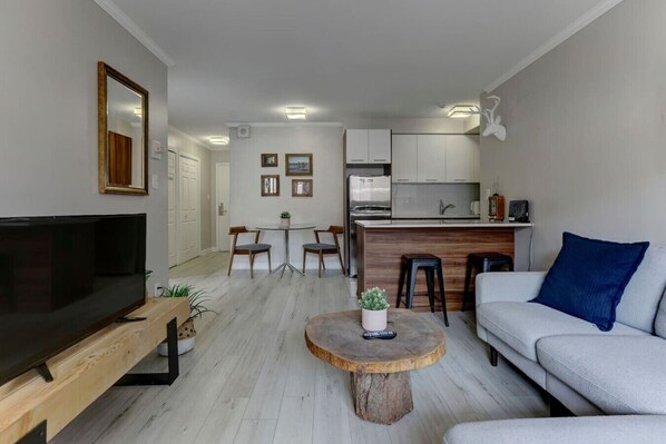 Modern comfort meets stylish design – unwind in this bright and inviting living space, perfect for relaxing after a day exploring Montreal