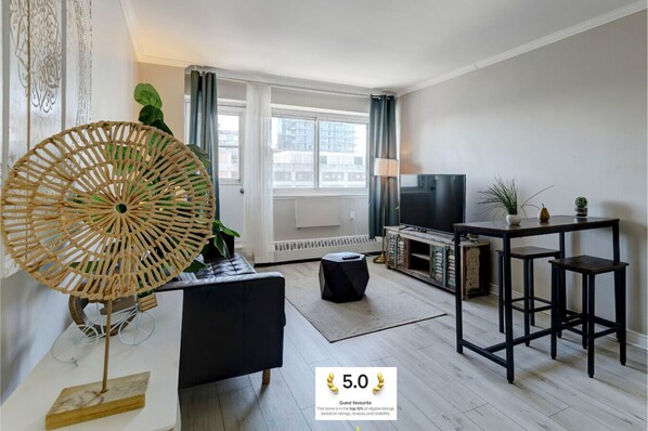 A bright and inviting living area with stylish decor, large windows, and a contemporary aesthetic.