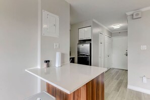 A sleek and modern kitchen with a spacious island, stainless steel appliances, and a stylish finish