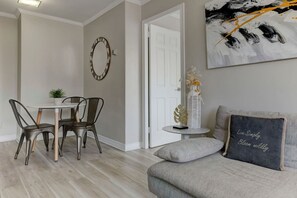 A seamless flow from the seating area to the dining space, showcasing elegant decor and thoughtful design.