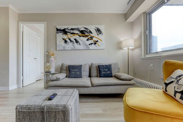 A different angle highlighting the modern sofa, decorative artwork, and a warm, inviting atmosphere.