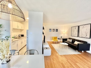 A bright and contemporary open-concept layout blending the kitchen, dining, and living areas seamlessly.