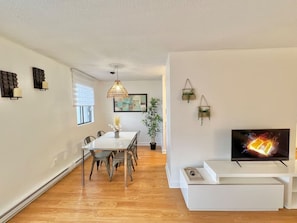 A sleek dining area featuring a cozy fireplace, creating the perfect setting for meals and gatherings.