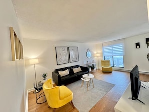 A beautifully lit living space with elegant furnishings, striking artwork, and a warm, welcoming ambiance.