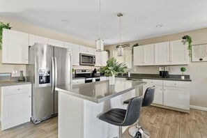 Kitchen: Included: Coffee/Kcups, Tea, creamers, sugar/sweetener Plastic and glass cups, outdoor beverage containers, coffee mugs Large cooking griddle, slow cookers, Large blender (ninja), pots, pans, cooking utensils, grilling utensils,