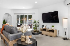 Enjoy the perfect blend of comfort and modern style in this thoughtfully designed living area. Sink into the plush sofa as you catch up on your favorite shows or movies on the 65” Smart TV equipped with Netflix.