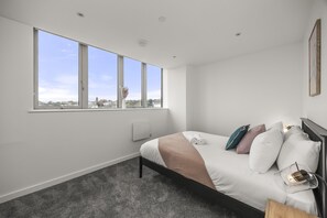 bedroom with a double bed, neutral décor, and bright natural light